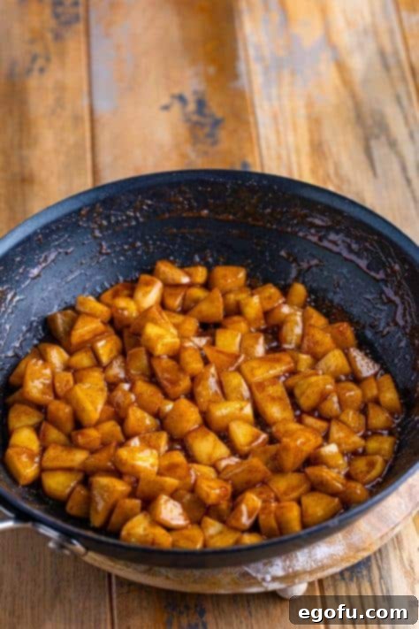 A bowl of apples, butter, brown sugar, and cinnamon.