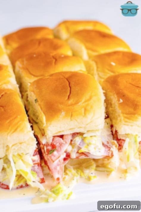 Slider rolls fully assembled with Italian Grinder fillings, ready for slicing.