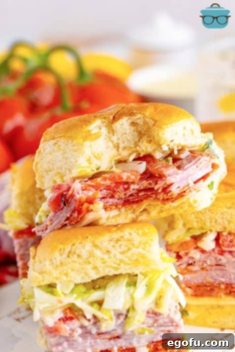 A close-up of an Italian Grinder Slider with a bite taken out, showcasing the delicious layers.