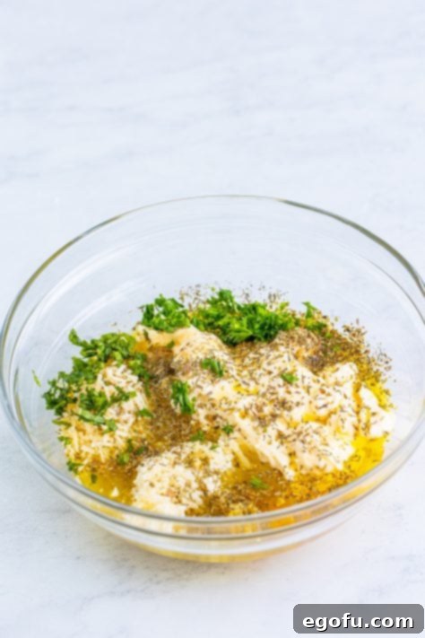 Salad dressing ingredients added to a bowl, ready to be whisked.