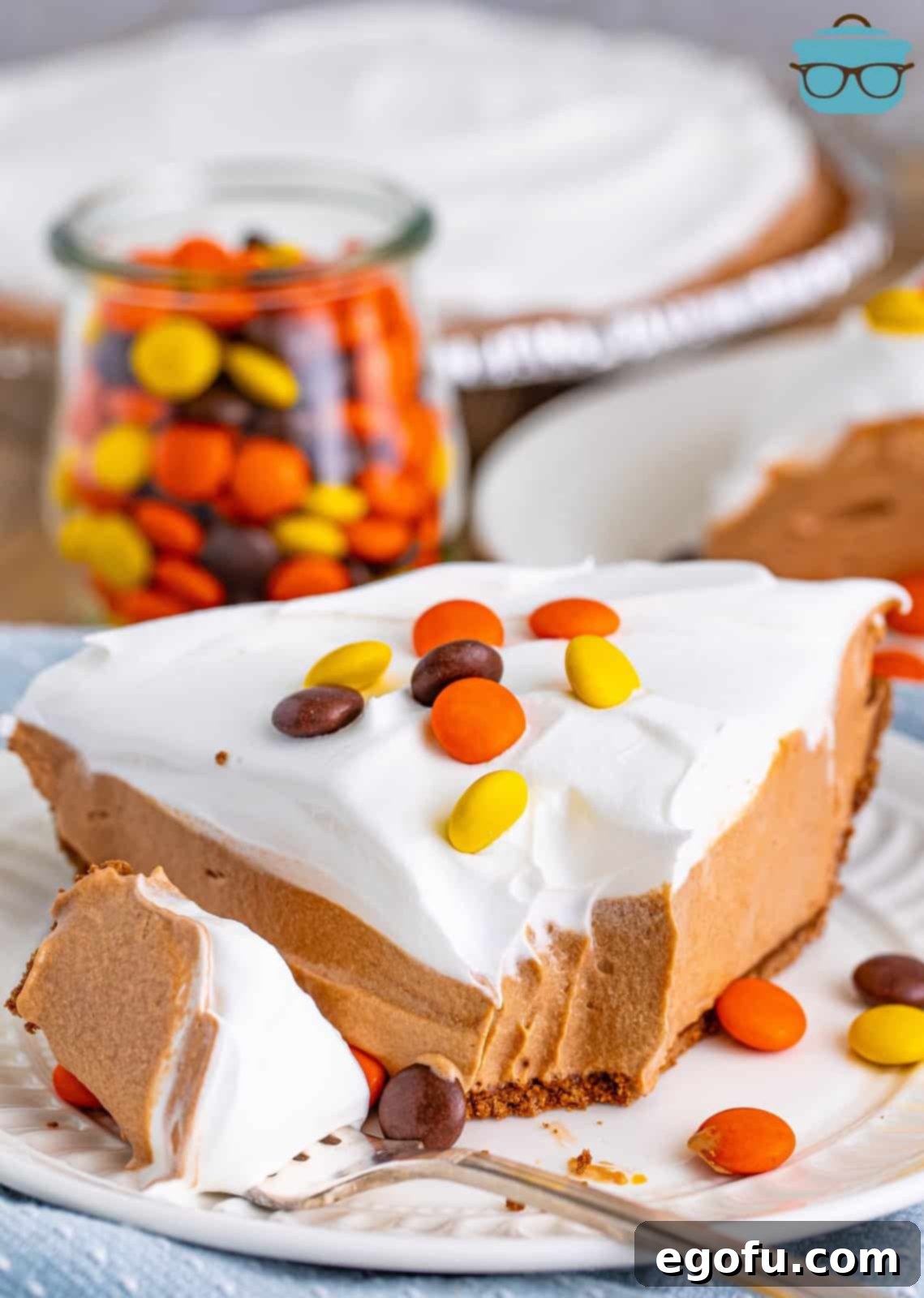 Creamy No Bake Chocolate Peanut Butter Bliss Pie 2 A delectable slice of No Bake Chocolate Peanut Butter Pie with a bite removed, showcasing its perfectly layered creamy chocolate and peanut butter filling.