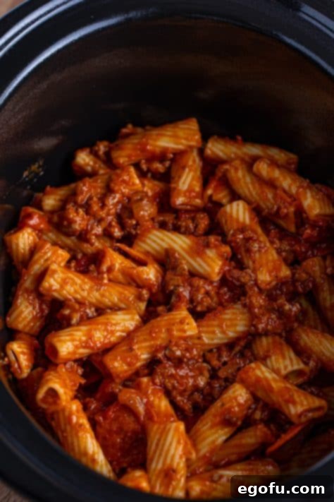 One-Pot Pizza Magic 10 Half the pizza pasta mixture layered in the bottom of the slow cooker.