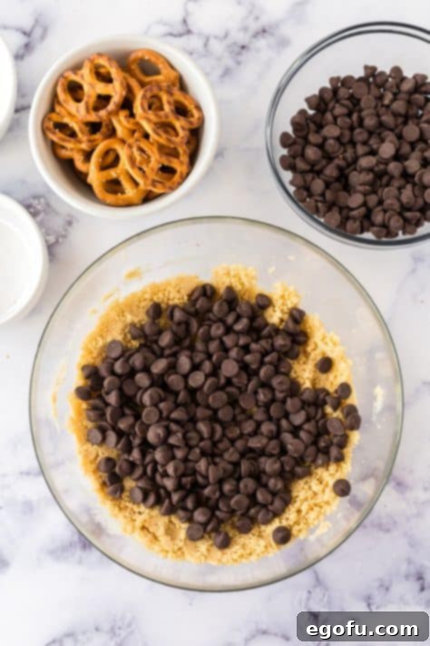 Chocolate chips in a bowl of cookie dough.