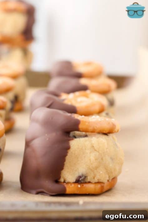 A few Cookie Dough Pretzel Bites on a piece of parchment paper.