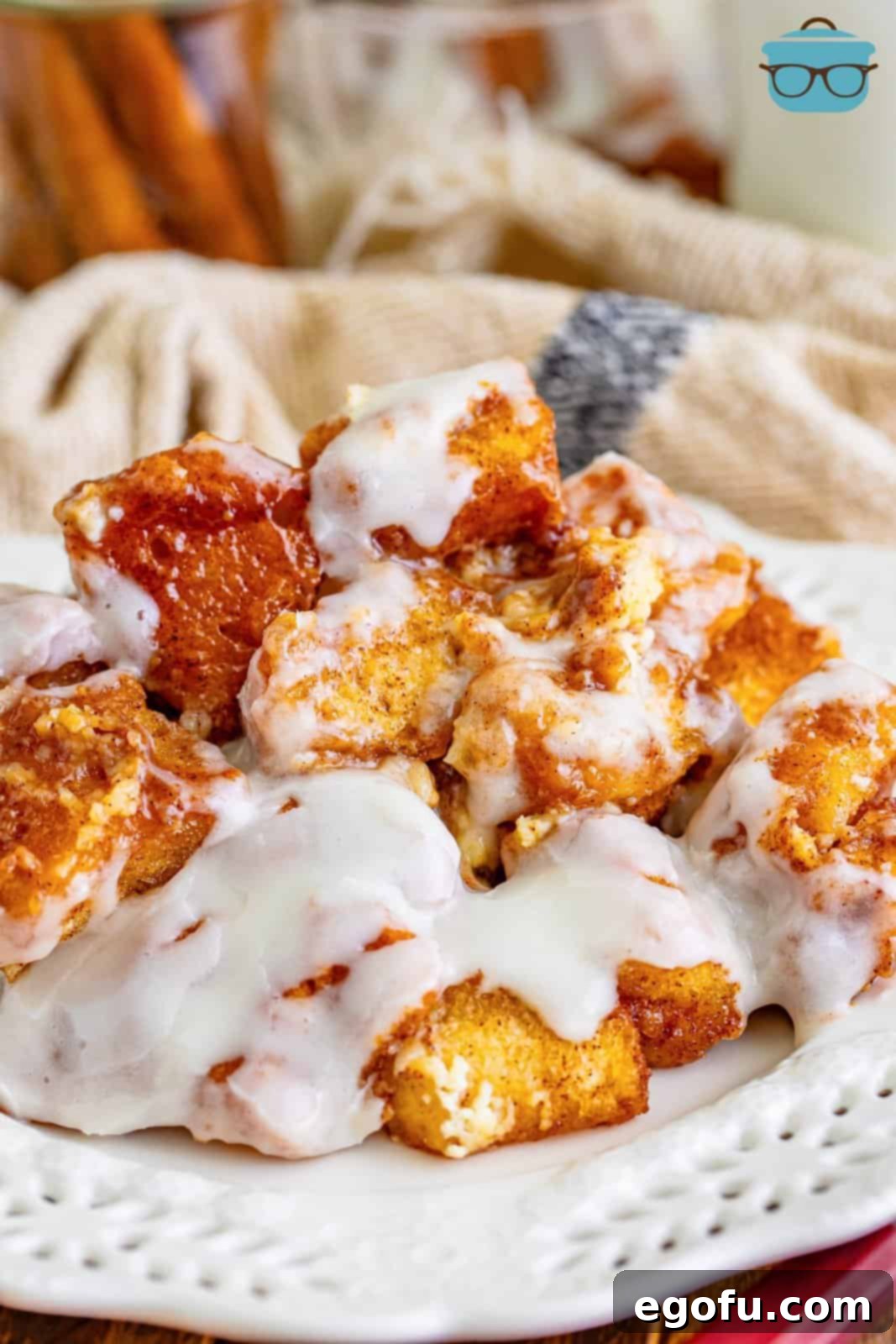 A close-up view of a perfectly baked Cinnamon Roll Bubble Up casserole, showcasing its golden-brown top, bubbly edges, and luscious cream cheese glaze.