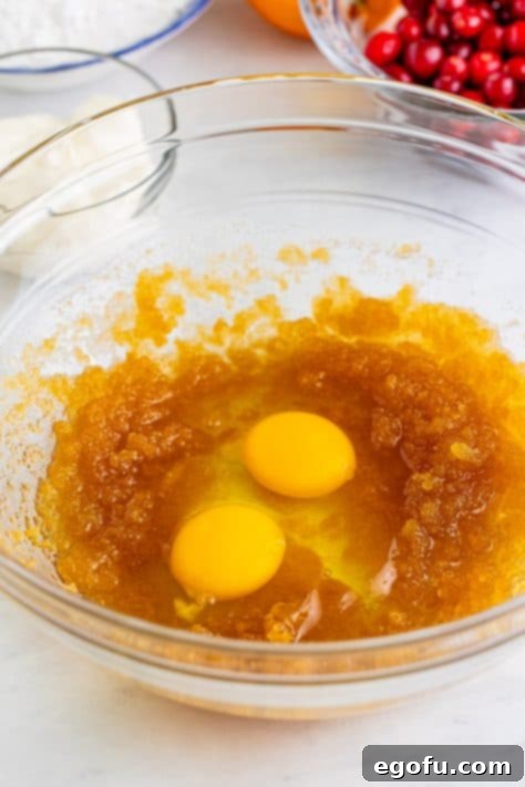 Eggs, oil, and brown sugar in a bowl.