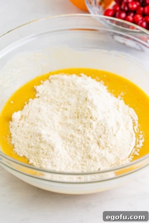 Flour mixture being added to the wet mixture for muffin batter.