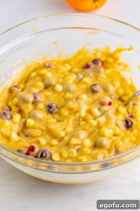 Cranberries and white chocolate chips in muffin batter.