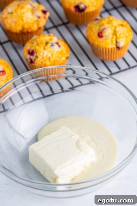 Cream cheese and white chocolate in a bowl.