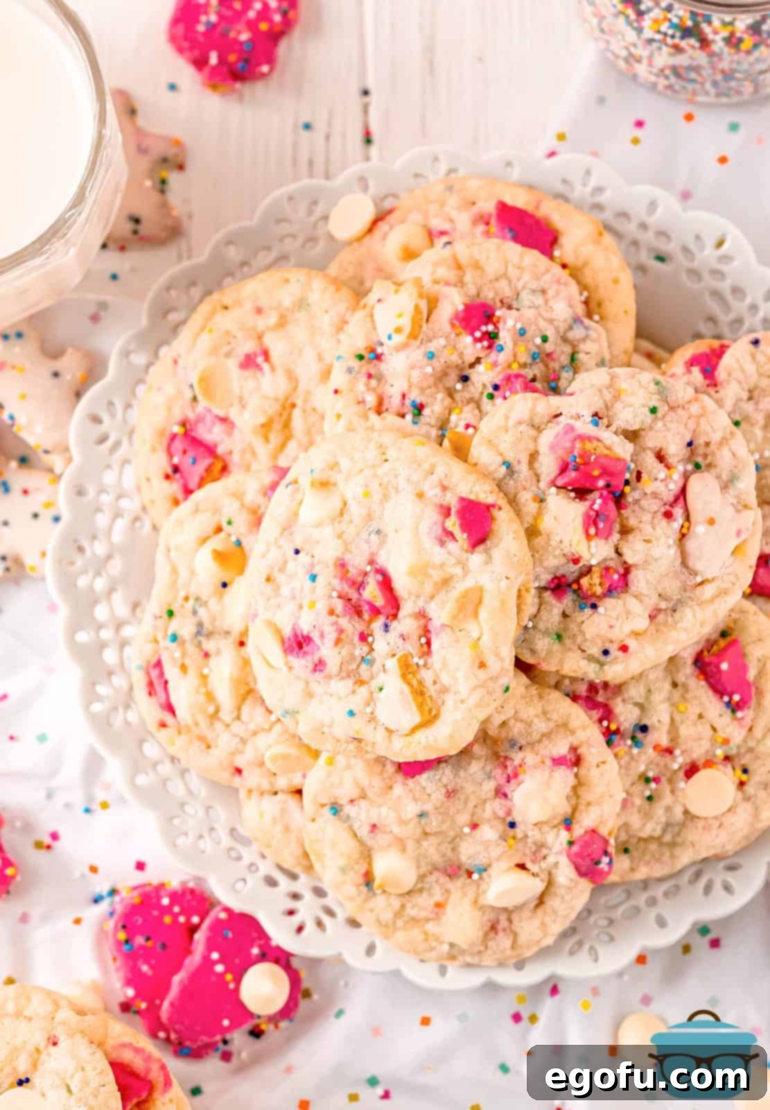 A charming plate filled with freshly baked Circus Animal Cookies, showing their vibrant pink and white frosting, colorful sprinkles, and pieces of animal crackers.