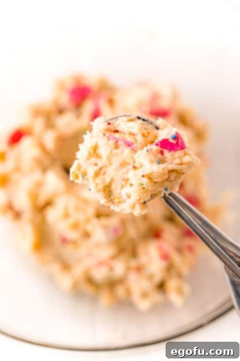 A cookie scoop holding some cookie dough.