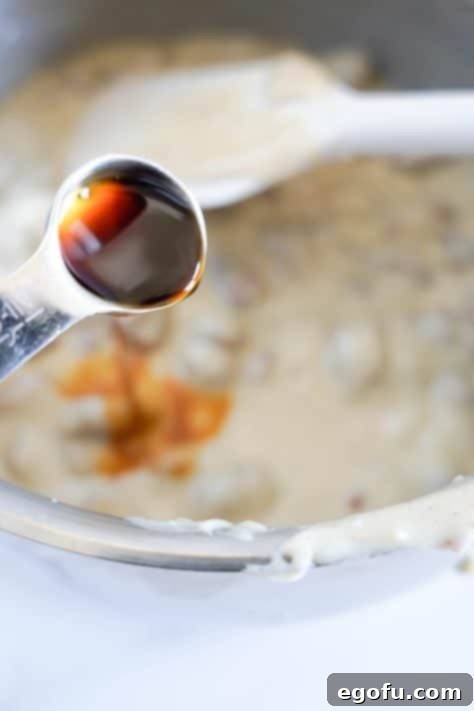 Vanilla extract being added to a fudge mixture.