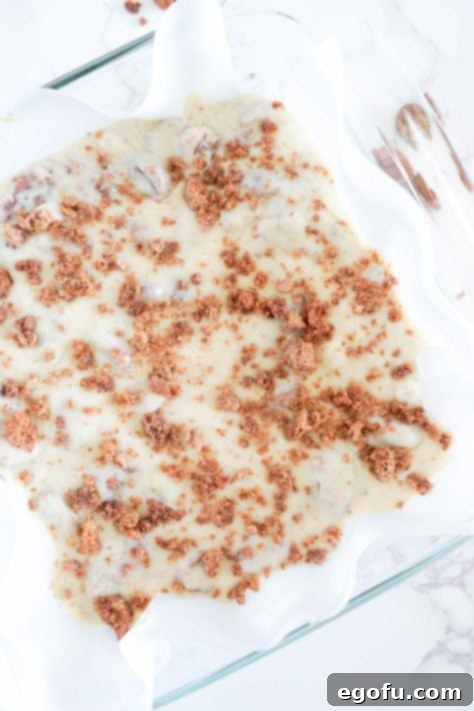 Candied pecans crushed on top of unset fudge.