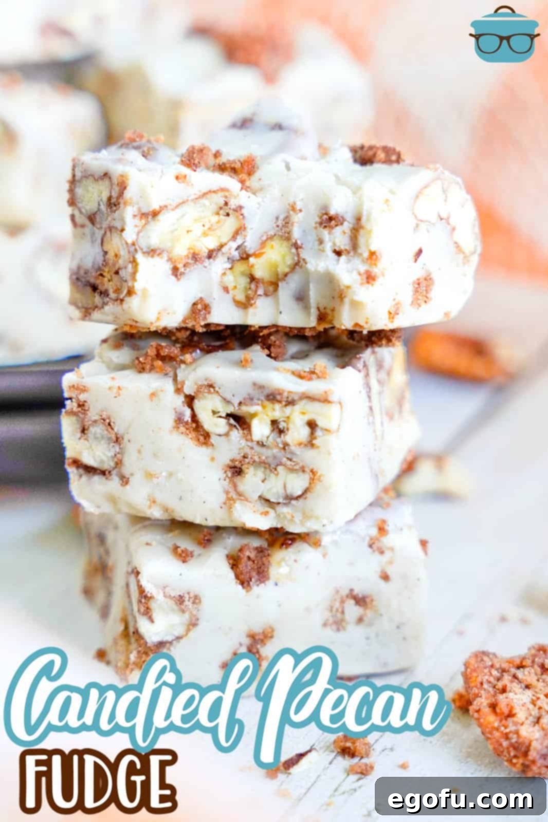 A stack of beautifully cut Candied Pecan Fudge squares, showing the creamy texture and pecan pieces.