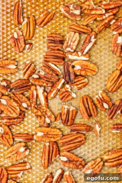 Crispy Holiday Brussels Sprouts 15 Pecans being toasted on a baking mat.
