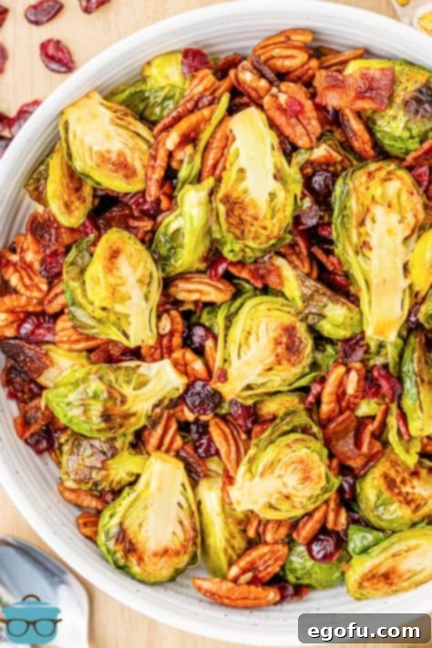 Crispy Holiday Brussels Sprouts 17 A white serving bowl of the finished Holiday Roasted Brussels Sprouts, garnished and ready to serve.