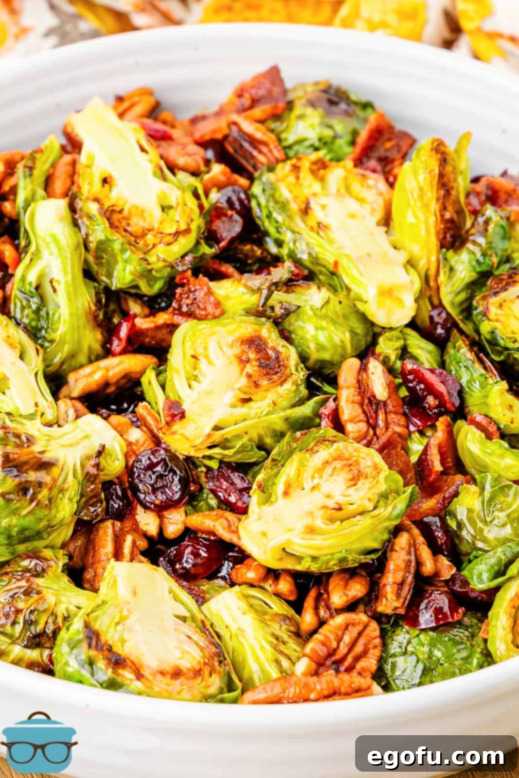 Crispy Holiday Brussels Sprouts 8 A beautiful white serving platter overflowing with the finished Holiday Roasted Brussels Sprouts, ready to be presented.
