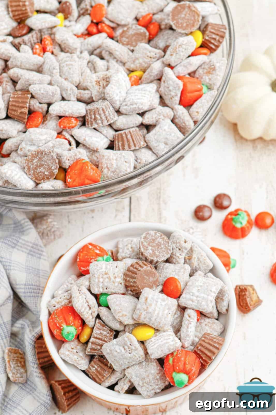 Harvest Puppy Chow Delight 7 A collection of small serving bowls, each filled with Thanksgiving Puppy Chow, beautifully arranged for a holiday spread.
