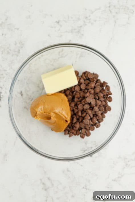 Harvest Puppy Chow Delight 9 A mixing bowl with chocolate chips, peanut butter, and butter, just melted and stirred.
