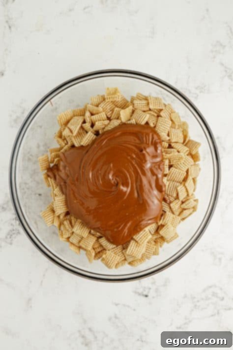Harvest Puppy Chow Delight 10 Melted chocolate mixture being poured over Chex cereal in a bowl.