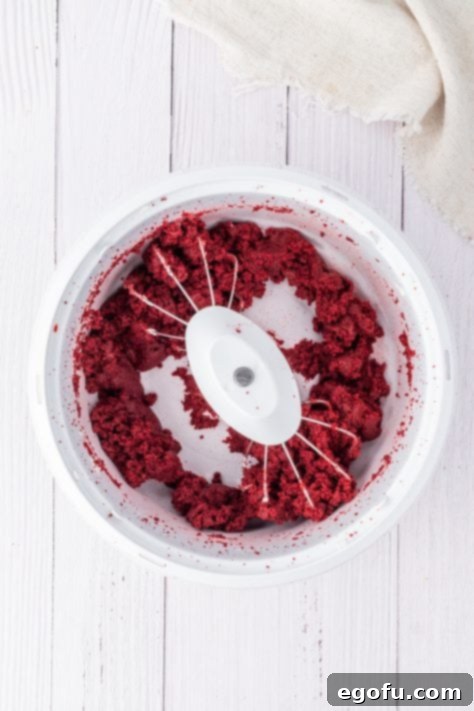 Red velvet cake crumbled up in a bowl.