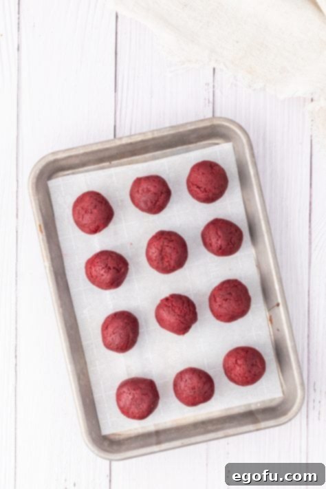 Unfrosted cake balls on a parchment lined baking sheet.