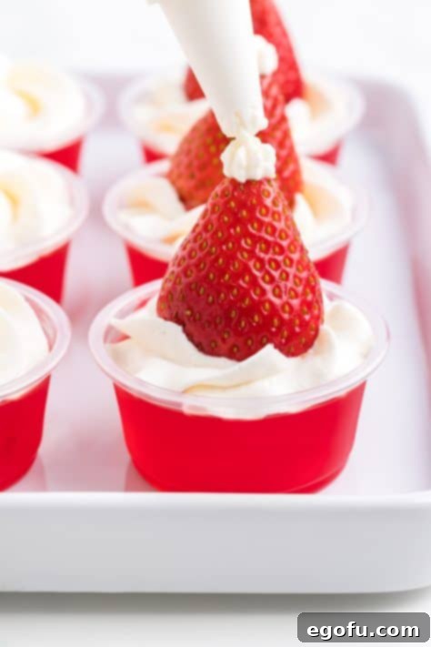 Spirited Santa Hat Shooters 15 Small dot of whipped cream on top of strawberry to form santa hat on a jello shot.