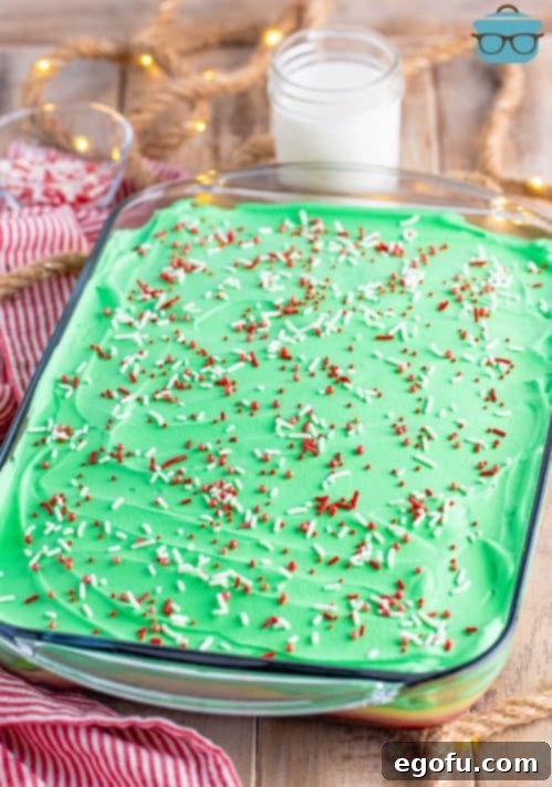 A Christmas poke cake with Christmas sprinkles.