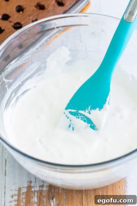 Marshmallow fluff and milk in a bowl.