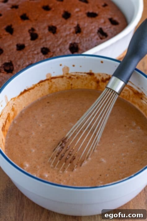 Peppermint Patty Poke Cake 12 Chocolate pudding in a bowl with a whisk.