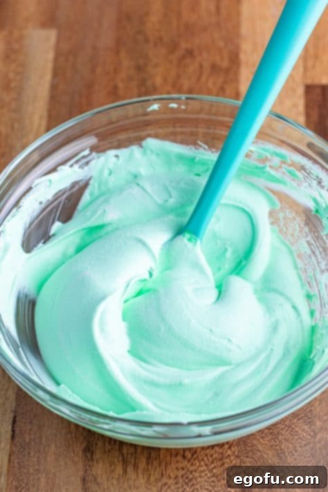 Peppermint Patty Poke Cake 14 Whipped topping, mint extract, and green food coloring all mixed together.