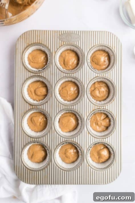 Cozy Gingerbread Cupcakes 11 Gingerbread cupcake batter in lined cupcake tins.