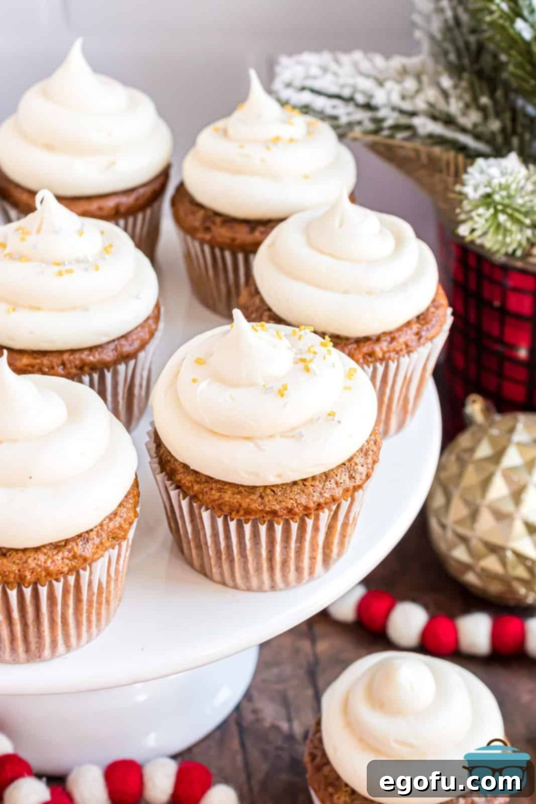 Cozy Gingerbread Cupcakes 7 A serving plate on a pedestal with beautifully frosted Gingerbread Cupcakes, ready for enjoyment.