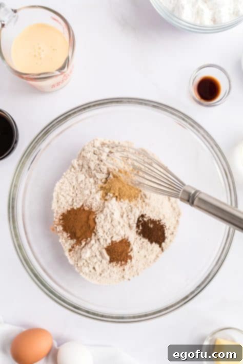 Cozy Gingerbread Cupcakes 9 A mixing bowl with spice cake mix, ginger, cinnamon, cloves, and nutmeg.