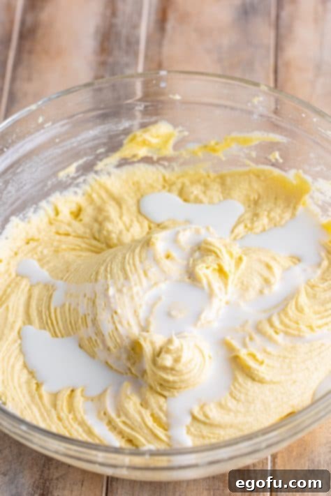 Milk being added to pound cake batter.