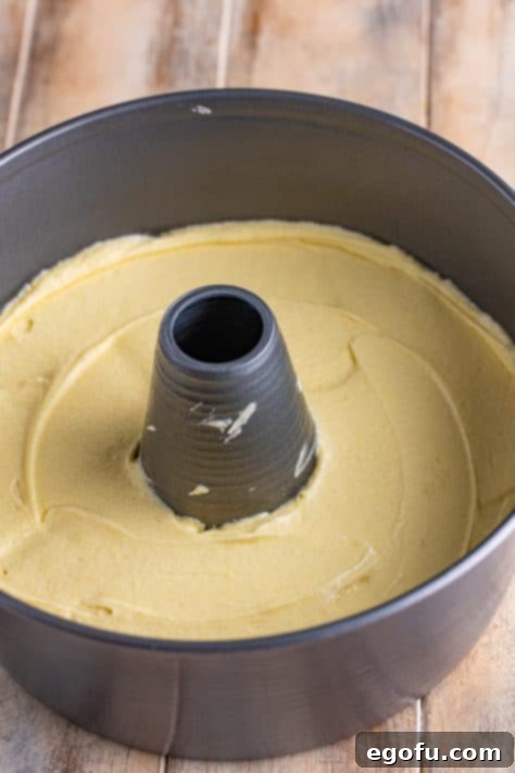 Pound cake batter spread into angel food pan.