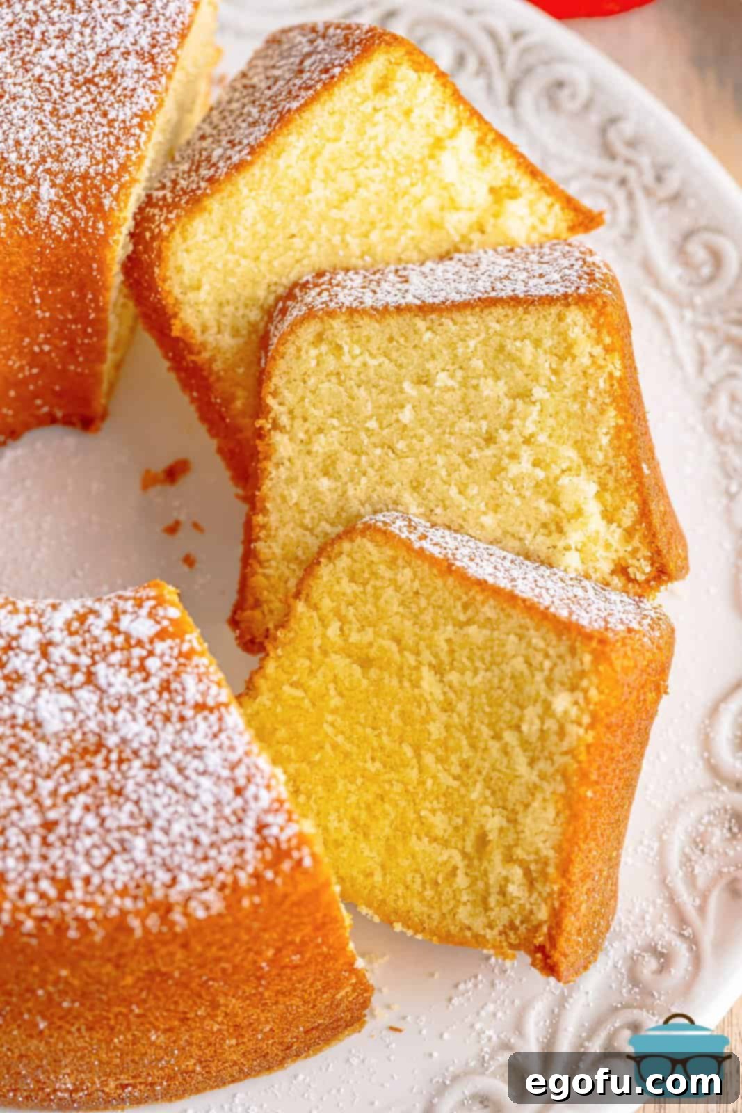 Several beautiful slices of Southern Pound Cake arranged neatly on a cake plate, ready to be served.