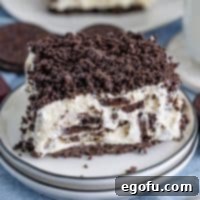 A large slice of No Bake Oreo Dessert on a serving plate.