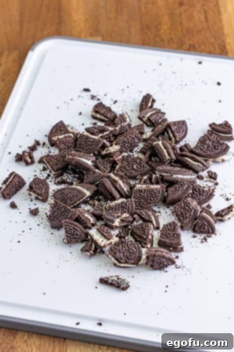 Chopped Oreos on a cutting board.