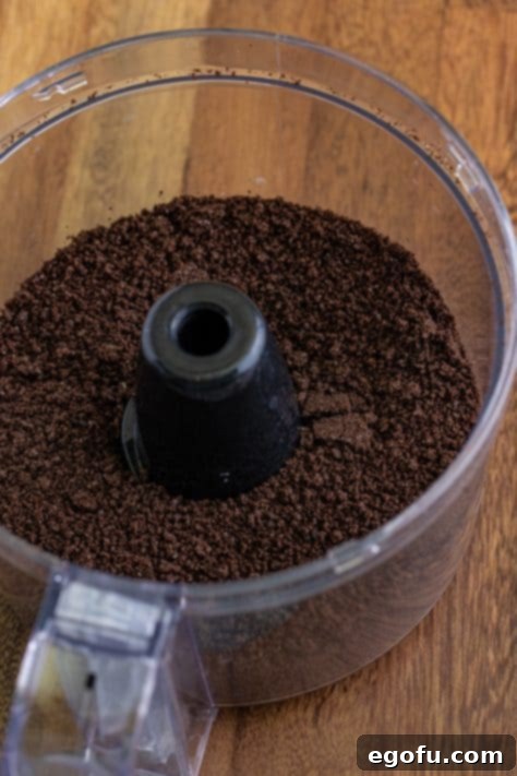 Oreo crumbs in a food processor bin.
