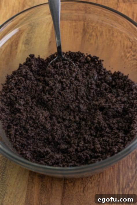 Oreo crumbs and butter in a mixing bowl.