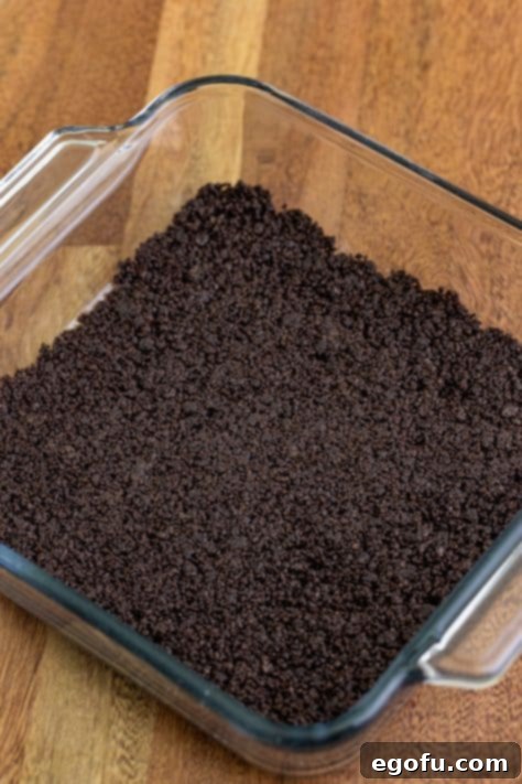 Butter and Oreo crumbs in a baking dish.