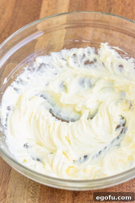 Cream cheese and powdered sugar creamed together in a mixing bowl.