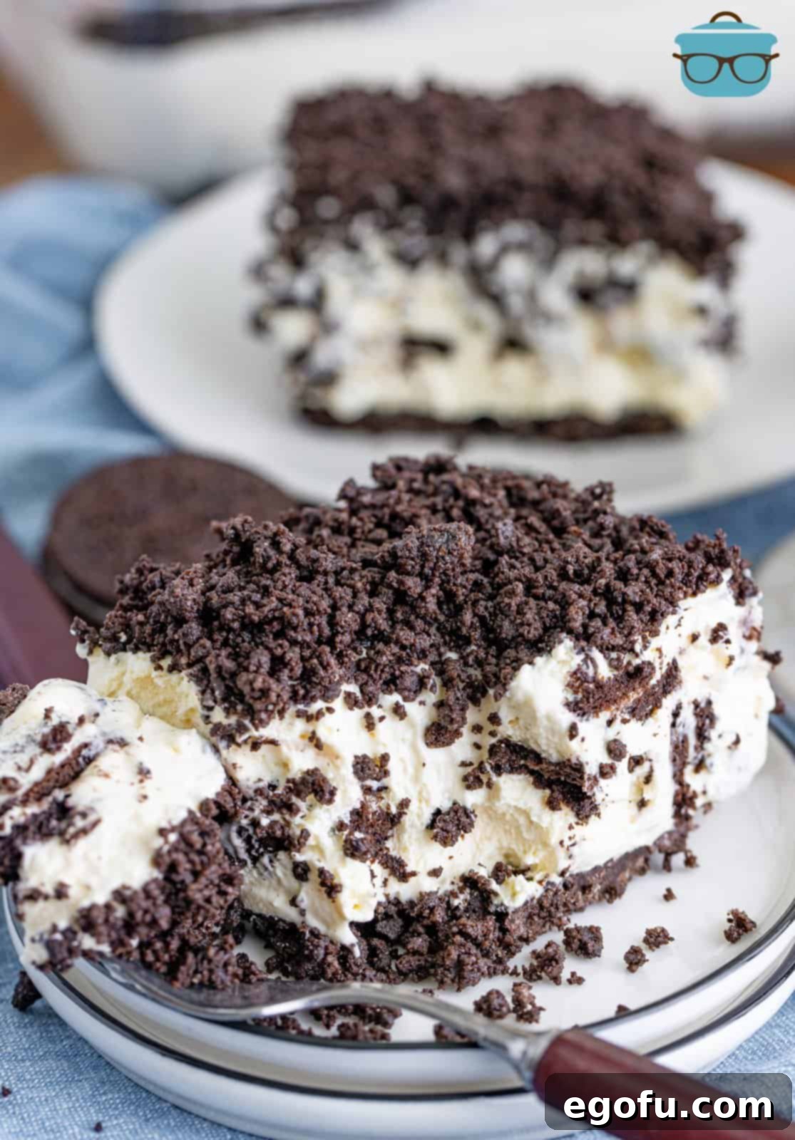 A few slices of No Bake Oreo Dessert on a few dessert plates.
