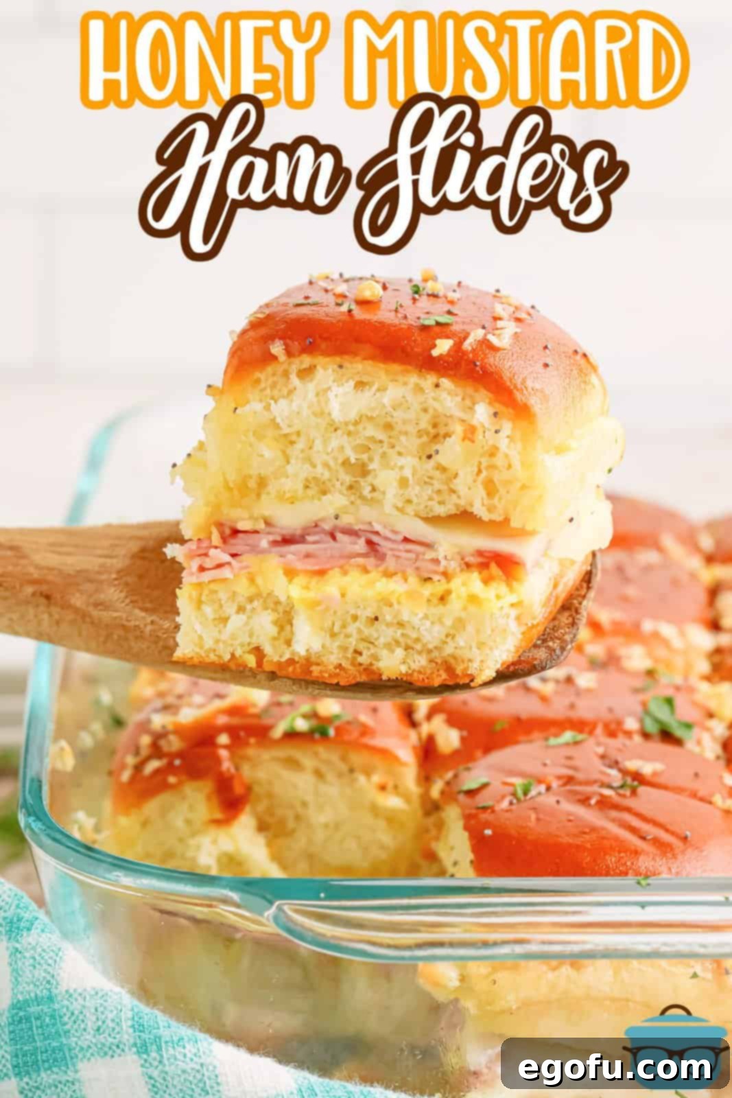 A glass baking dish filled with prepared Honey Mustard Ham Sliders, ready to be served.