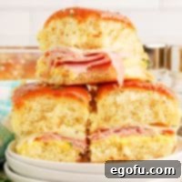 A few serving plates with a small pile of Honey Mustard Ham Sliders.