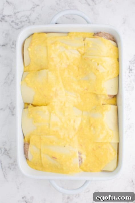 Cream of chicken soup on top of Swiss cheese covered chicken.