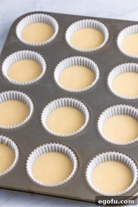 Bridal Bliss Bites 15 Cupcake batter added to cupcake liners in a cupcake pan.