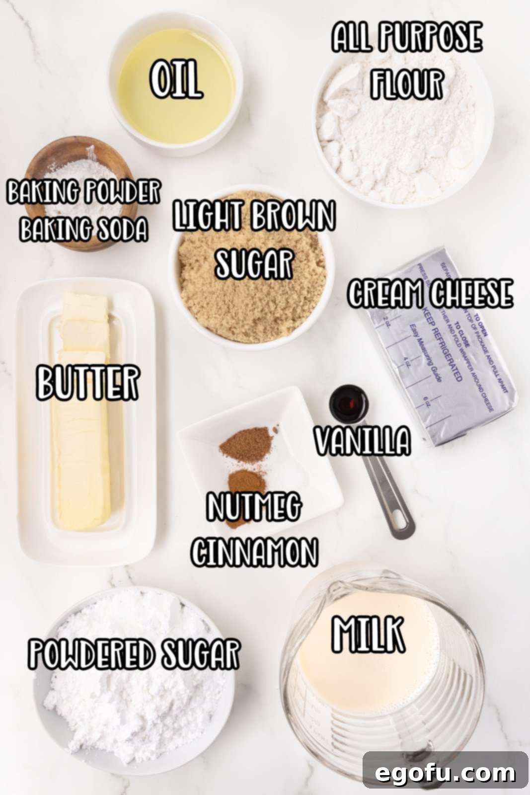 An array of ingredients laid out for Cinnamon Roll Pancakes, including flour, sugar, butter, cream cheese, vanilla, and spices.