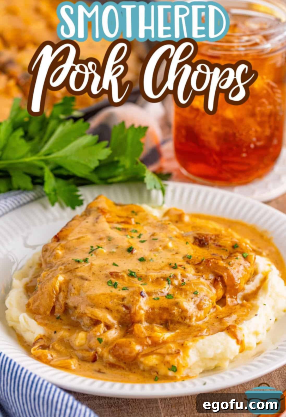 A plate with mashed potatoes and Smothered Pork Chops. 